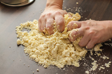 Mixing fresh Dough with a hands on the table