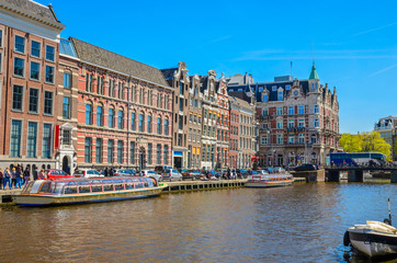 Traditional old buildings and and boats in Amsterdam, Netherlands