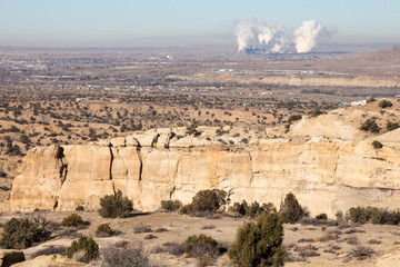 Sandstone bluffs and a coal fired power plant in New Mexico