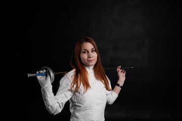 Beautiful girl keep sword and look to the camera. Sport fencing concept for brave woman.