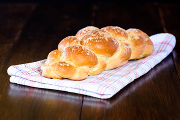 Challah bread on wooden table