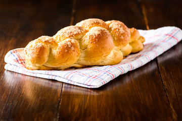 Challah bread on wooden table