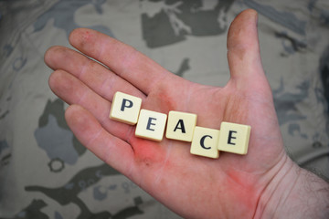 letters with text peace on a dirty hand. concept