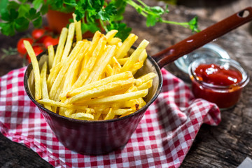 Homemade french fries on wooden  background