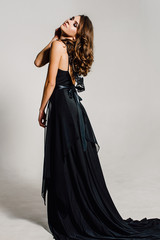 Individuality. Thoughtful Elegant Lady in Black Prom Evening Dress. Studio retouched photo.