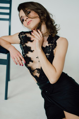 Individuality. Thoughtful Elegant Lady in Black Prom Evening Dress. Studio retouched photo.
