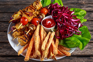 Chicken skewers marinated in turmeric yogurt served with sweet potato and vegetables