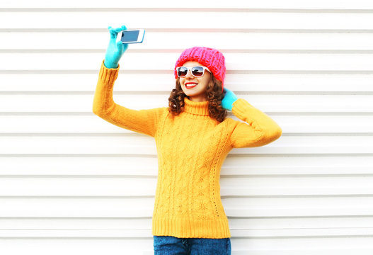 Fashion happy smiling young woman taking picture self portrait o