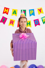 Fototapeta na wymiar Girl holding a big box with a gift. Garland with the Inscription happy birthday. white background.