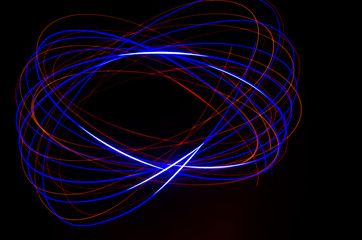 Light spiral, red and blue lines on a black background