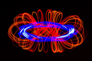 Light spiral, red and blue lines on a black background