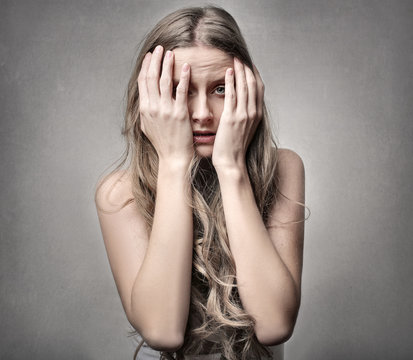 Girl hiding behing hands