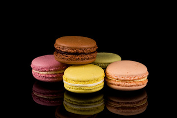 Colorful macaroon over black background