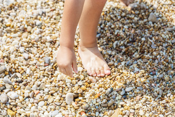 Child hands collect pebbles