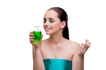 Woman holding a bottle of green perfume