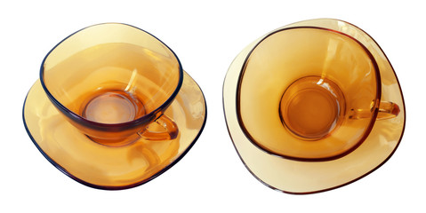 Isolated transparent amber tea cup and saucer
