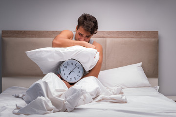 Man having trouble waking up in the morning
