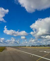 Fototapeta premium Runway Under Puffy Clouds