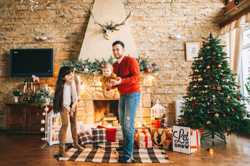 Young family in Christmas interior