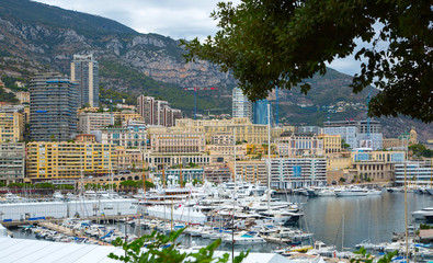 Fototapeta na wymiar Principality of Monaco. View of the seaport and the city of Monte Carlo with luxury yachts and sail boats 