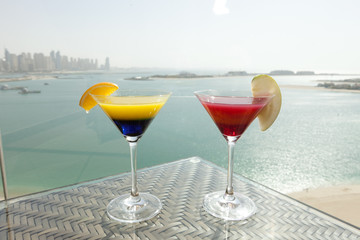 cocktail glass on table with sea background