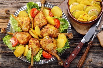 Chicken legs and baked dill potatoes with vegetable salad