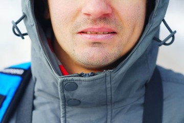 Closeup of a well-groomed man's face. Care for chapped lips in the cold season. Concept of a...