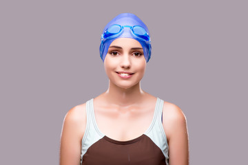 Woman swimmer against grey background