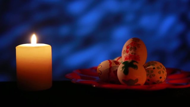 Easter candle with ornaments in the dark