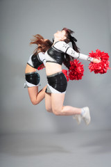 Two Cheerleaders Jumping
