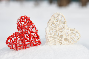 Red and white hearts on snow winter background. Love and Valentines Days concept