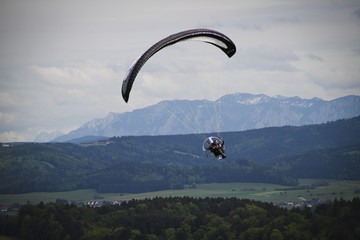 Paraglider flying in the panorama of the alps