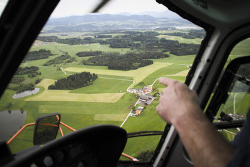 Sightseeing flight over green landscape with barns