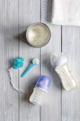 preparation of mixture baby feeding on wooden background top view