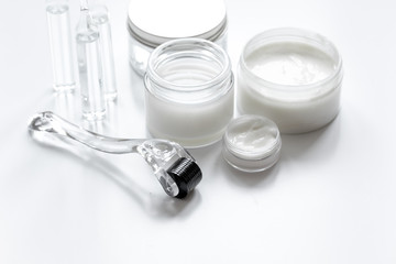 concept beautician desktop with mezoroller - mesotherapy on white background