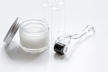 concept beautician desktop with mezoroller - mesotherapy on white background