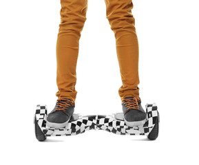 Legs of teenager riding on gyroscooter against white background