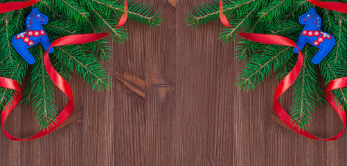Christmas background with branches of fir and decorations on a b