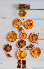 Figure Christmas tree of dried citrus fruit slices and cinnamon