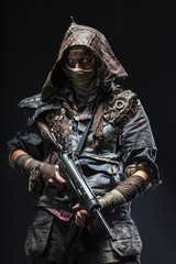 Nuclear post apocalypse life after doomsday concept. Grimy survivor with homemade weapons. Studio...