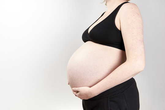 Pregnant woman belly over white background