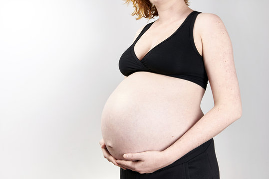 Pregnant woman belly over white background