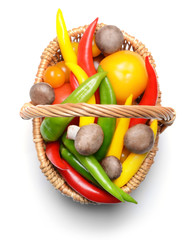 Group of fresh vegetables in basket on white background