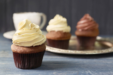Tasty chocolate cupcake on wooden table