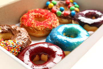 Delicious donuts in box, closeup