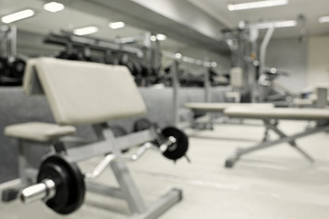 Fototapeta na wymiar Gym interior with equipment, blurred background
