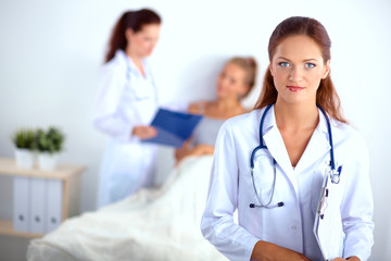Woman doctor with folder standing at hospital