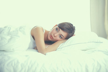 Obraz na płótnie Canvas Beautiful girl sleeps in the bedroom, lying on bed