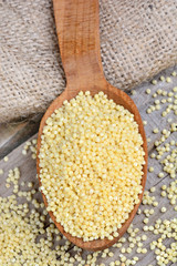 Wooden spoon with millet seeds