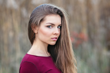 Naklejka premium Portrait of pensive sad lonely innocent Caucasian Russian blonde young beautiful woman girl with long hair outside looking in camera, autumn fall summer shoot